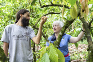 local guide shows a tourist a tree in Ecuador on a Purposeful Nomad trip
