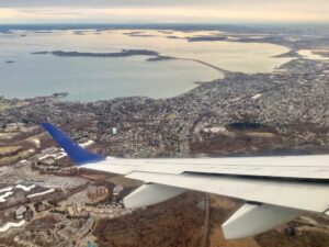 looking out of airplane over wing with Boston, Massachusetts, below